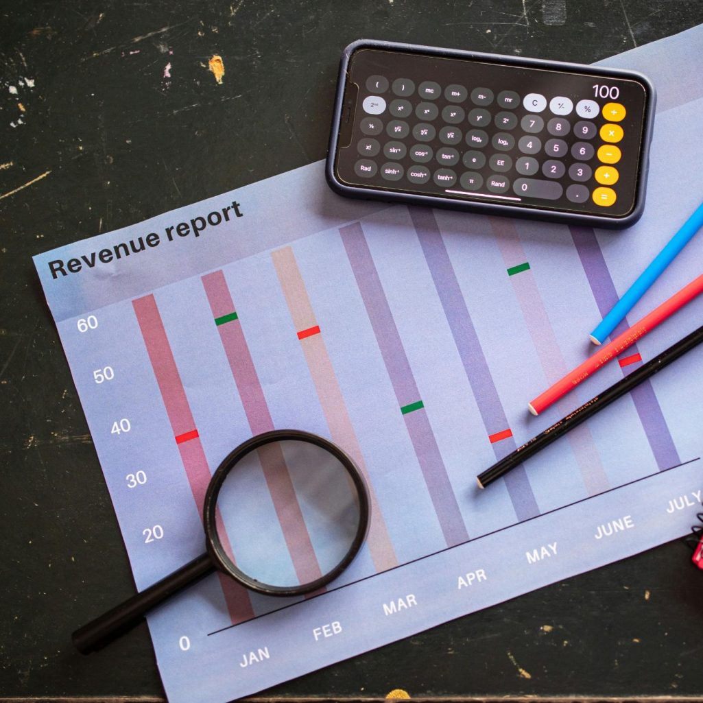 Calculator and 1099 tax forms on a desk, illustrating year-end contractor reporting for small businesses